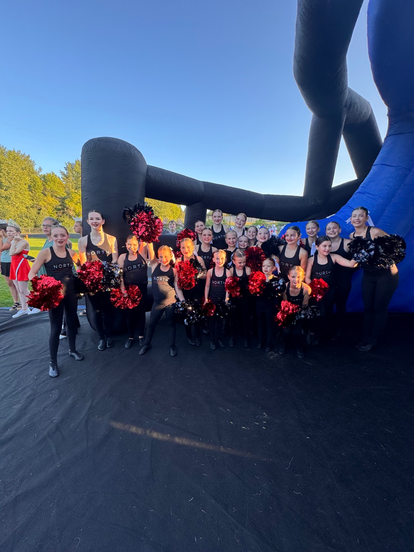 North Dance Studio group photo with pom-poms at an event