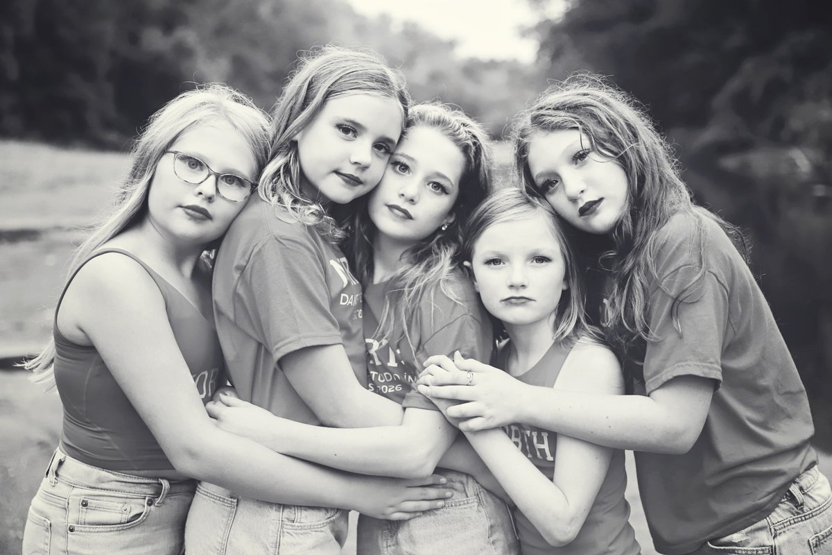 Black and white photo of five North Dance Studio dancers hugging together