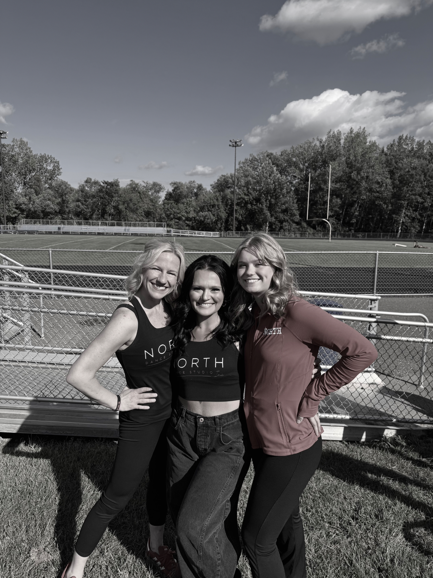 North Dance Studio instructors smiling at the field