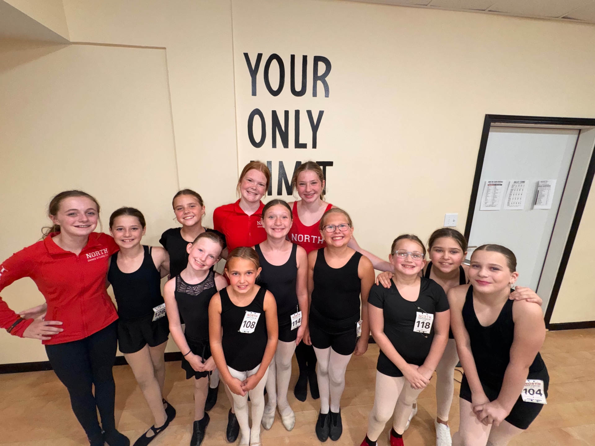 Dancers and instructors beneath the 'Your Only Limit Is You' mural