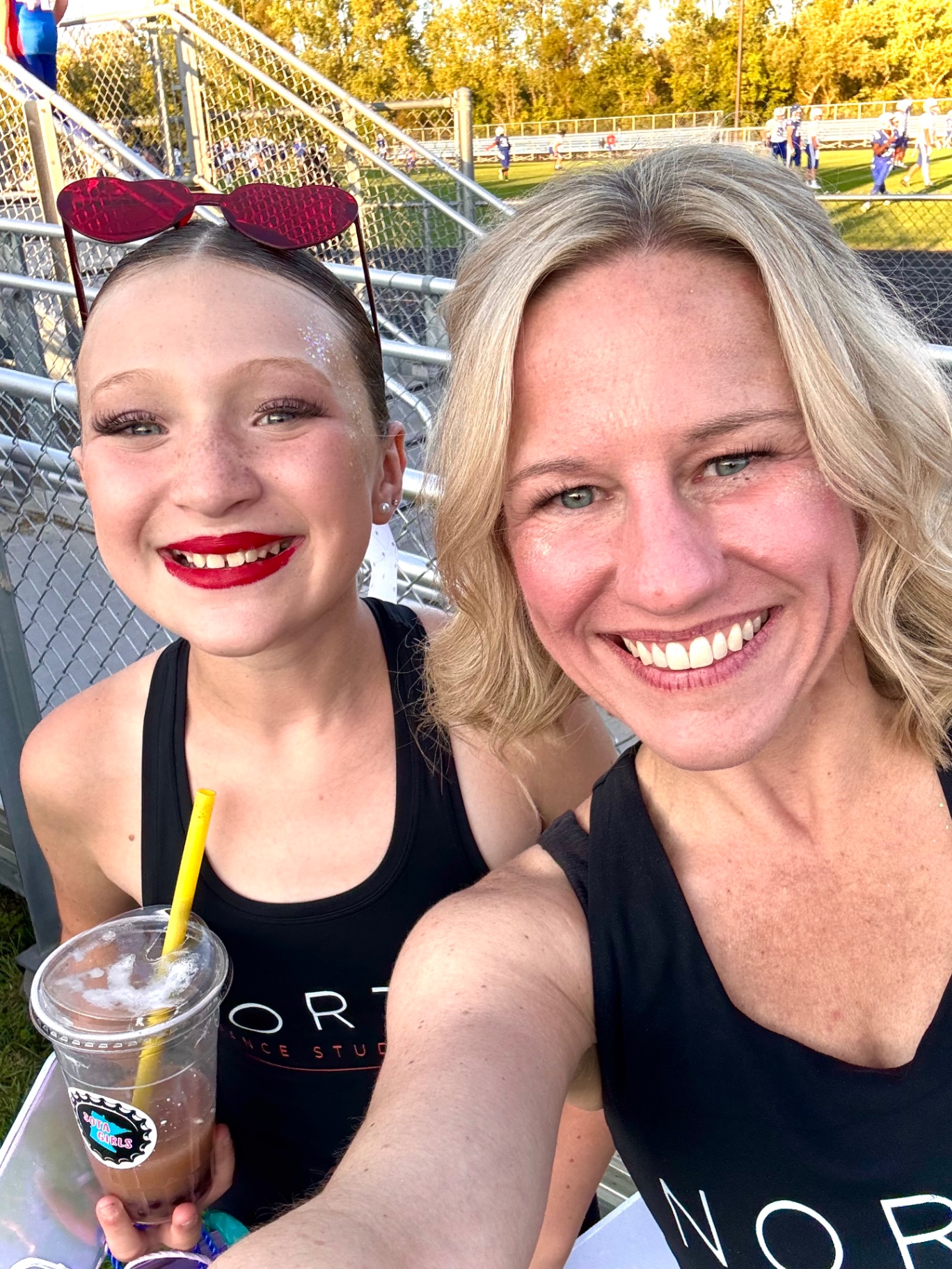Miss Kristy and a dancer taking a selfie at the football game