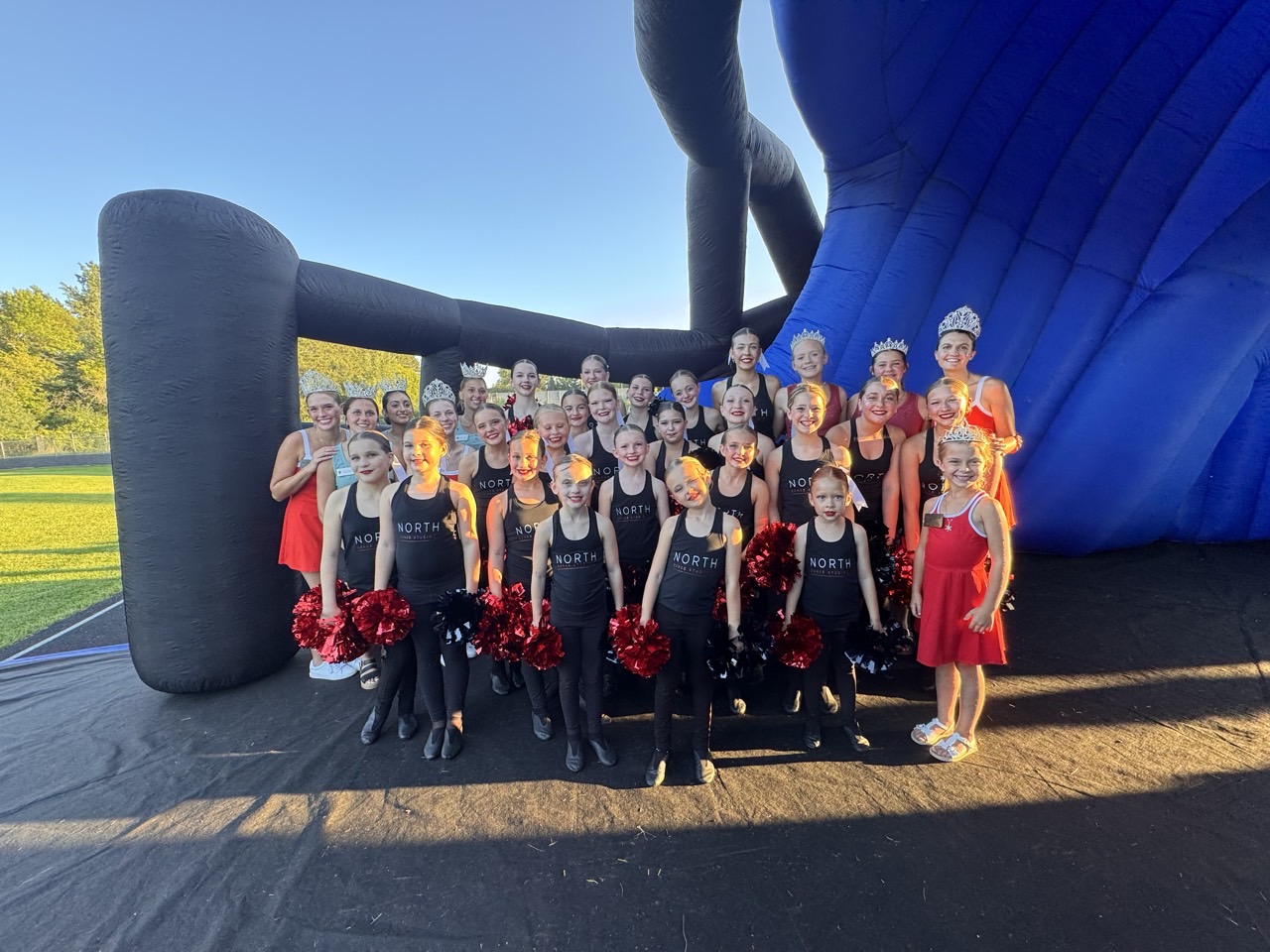 North Dance Studio dancers and royalty at the football field